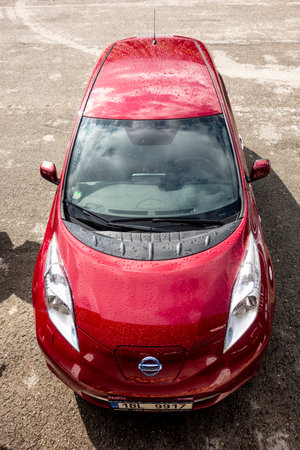 TERCHOVA, SLOVAKIA - JULY 6, 2017: The frontal part of red Nissan Leaf electric car after rain in sunny weatherのeditorial素材