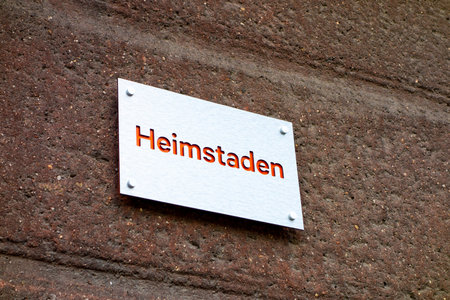 HAVIROV, CZECH REPUBLIC - JUNE 25, 2020: The bright silver plate of Heimstaden company ona red wall of rented houseのeditorial素材