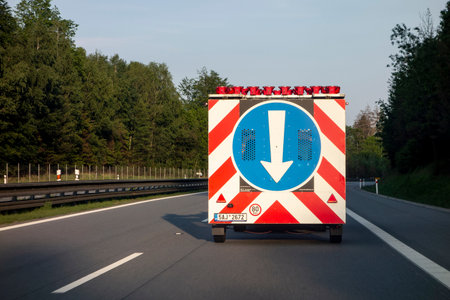 CZECH REPUBLIC - MAY 26, 2019: The road assistance and construction vehicle with a traffic sign controlling the traffic situation in Czech Republicのeditorial素材