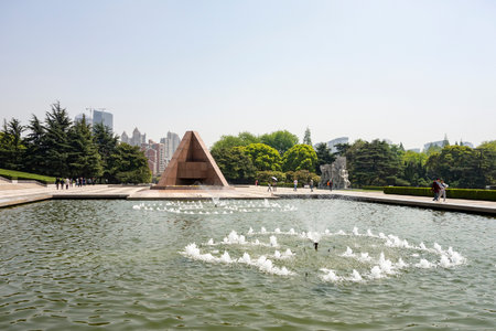 SHANGHAI, CHINA - APRIL 15, 2017: The memorial, sculptures and fountain in a pool in Longhua Gardens Park in center of Shanghai, Chinaのeditorial素材