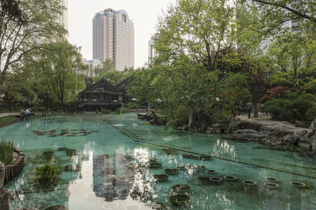 SHANGHAI, CHINA - JUNE 28, 2021: Pond in Jingan Park in centre of Shanghai, China with skyscrapers in the backgroundのeditorial素材