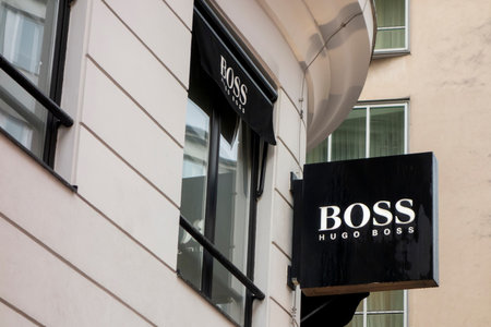 VIENNA, AUSTRIA - JULY 28, 2021: The banner of Hugo Boss company above the entrance to its store which sells luxury clothingのeditorial素材