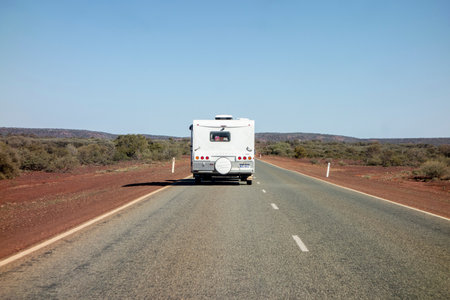 NEWHAM, WESTERN AUSTRALIA - JULY 11, 2018: Rear of car towing a caravan in Western Australia in remote outback landscapeのeditorial素材