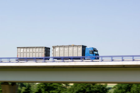 OSTRAVA, CZECH REPUBLIC - MAY 6, 2021: Blue Volvo truck of Smolo company which transports waste with motion blur effect on a bridgeのeditorial素材