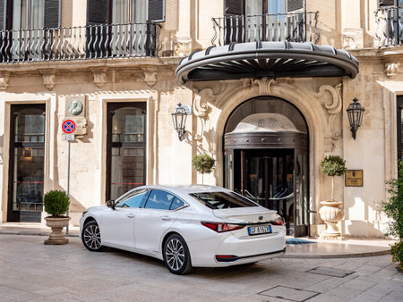 LECCE, ITALY - OCTOBER 27, 2021: Luxury Lexus ES 300h sedan parked in front of the luxurious hotelのeditorial素材