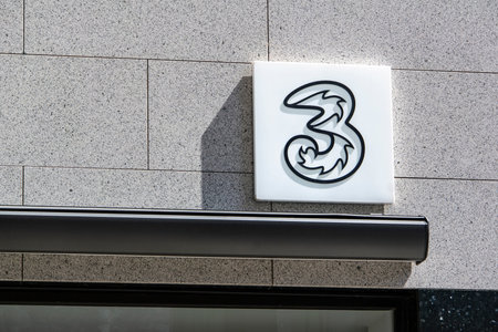 VIENNA, AUSTRIA - JULY 27, 2021: The logo of Drei (Three) company, telecommunication services provider, at storefrontのeditorial素材