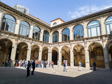 BOLOGNA, ITALY - APRIL 19, 2022: Courtyard of Biblioteca Comunale dell Archiginnasio library in Bologna, Italy with visiting touristsのeditorial素材