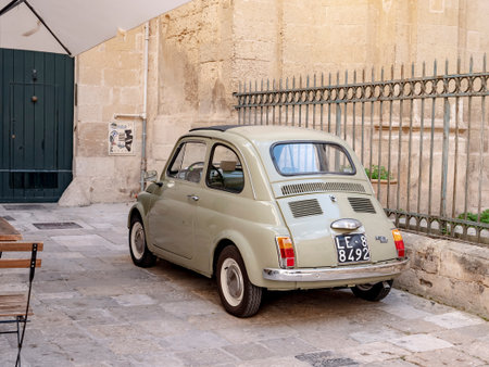 LECCE, ITALY - OCTOBER 27, 2021: Legendardy Fiat 500 vintage car with original registration plate in Lecce streetのeditorial素材