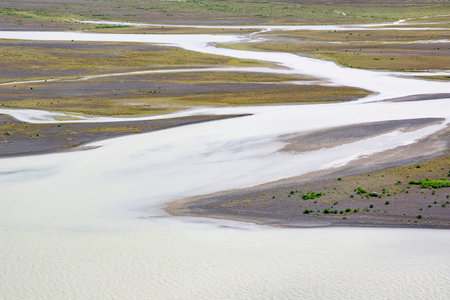 Thjorsa river in Iceland with muddy waters and rocky shoreの写真素材
