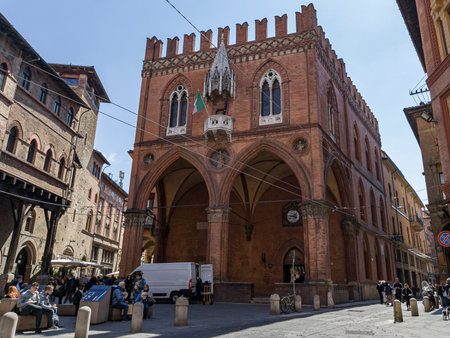 BOLOGNA, ITALY - APRIL 19, 2022: Palazzo della Mercanzia buiilding in Bologna, Italy with touristsのeditorial素材