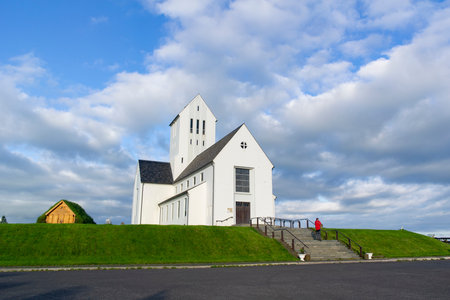 SKALHOLT, ICELAND - JUNE 28, 2014: Skalholt church in Iceland in with staircase, a tourist taking pictures and blue skyのeditorial素材