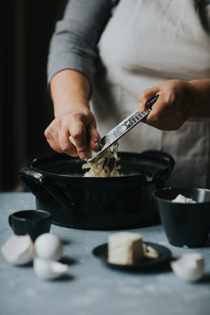 Woman grater margarine. Preparing doughの写真素材