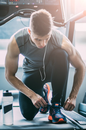 Portrait of a man tying shoelaces