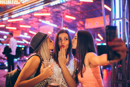 Girls having fun and taking selfie at music festivalの写真素材