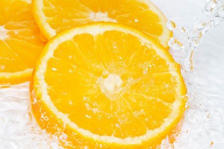 Fresh cut orange under the water streamの写真素材