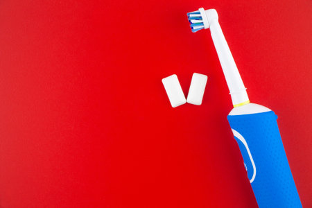 Electric toothbrush and two chewing gums.