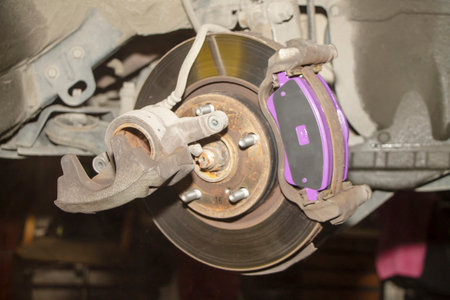 A hand technical specialist repairing the brake system of the modern car.の写真素材