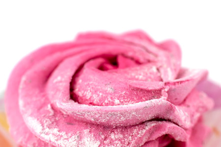 Marshmallows in the shape of a rose. Closeup on a white background. The center of focus. At the edges there is no focus.の写真素材