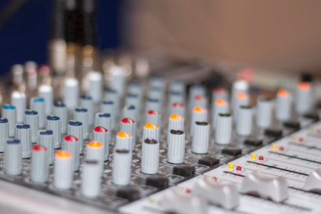 Audio mixing console. Knobs and controls on modern audio mixing console