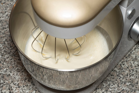 The process of whipping of batter in a planetary mixer. Selective focus.の写真素材