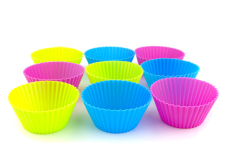 Colourful silicone form for cooking cupcake on a white background.の写真素材