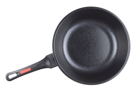 Black frying pan with nonstick surface isolated on white background, closeup, top view.の写真素材