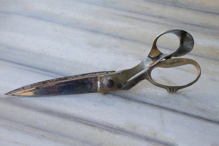 Old, worn scissors of a tailor for sewing top clothes.の写真素材