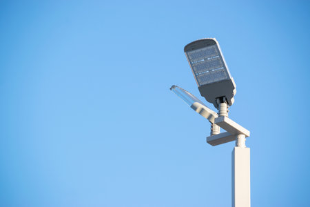 Solar panel with lamp under blue sky for energy power concept.