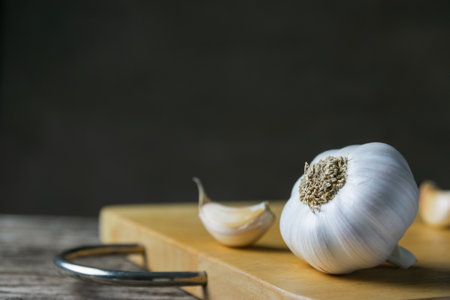 Closeup garlic on wooden texture on for cooking on dark backgroundの写真素材