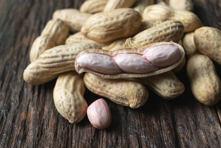 close- up from natural peanut on dark wooden this concept is for agriculture or health.