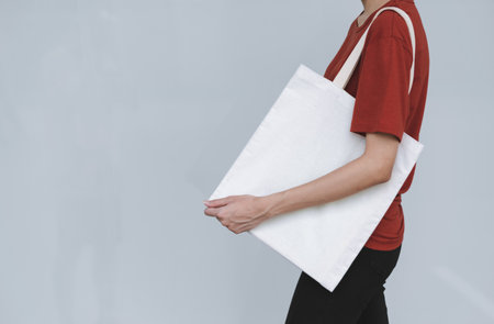 woman carry bag on gray background in save earth concept or say no plastic bag.の写真素材