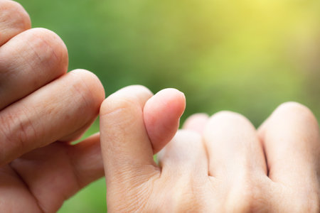 Pinky fingers of buddies in nature background promise is important for people in the world.