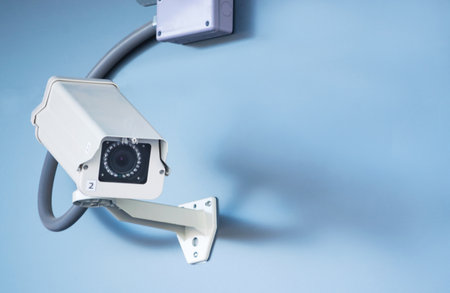 CCTV overhead for security in town on the blue wall background.の写真素材