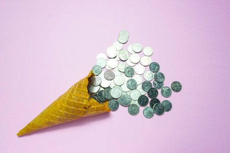 Top view ice cream cone with coins for idea concept put on pink pastel background.の写真素材