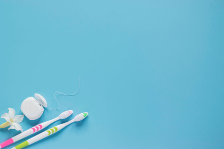 Top view dental floss and toothbrush with copy space on blue background.の写真素材