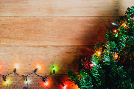 Top view christmas background and lights tree on wooden with copy space.の写真素材