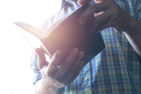 Man hold a book for reading to get knowledge.の写真素材
