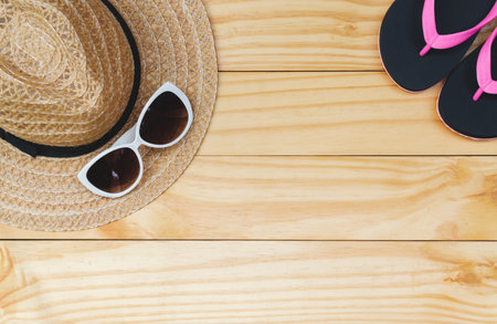 Flat lay, top view with hat,slippers,sunglasses for travel,summer and holiday concept on soft blue background.の写真素材