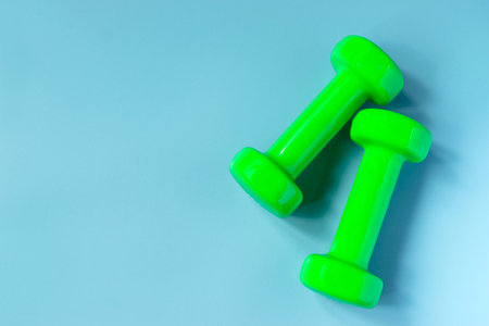 Top view dumbbells with measuring for diet or sport exercise concept on blue background.の写真素材