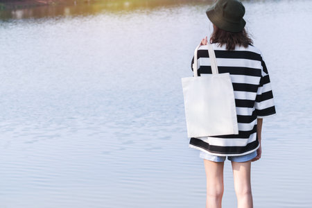 woman carry bag on nature background in save earth concept or say no plastic bag.