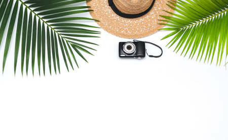 Flat lay traveler accessories, hat, camera  on white background. travel, summer and holiday concept.の写真素材