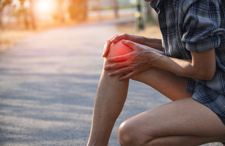 Woman walking on the road get accident for her knee the image is for health concept.の写真素材