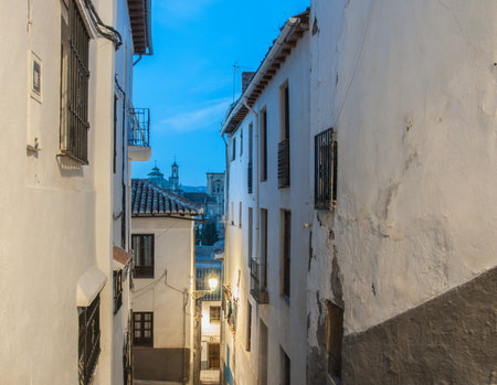 A narrow street in an old town at nightの写真素材