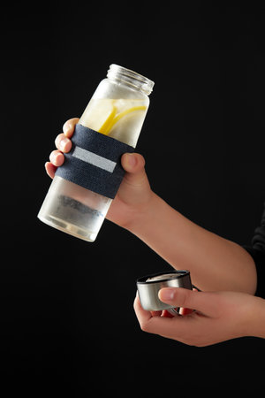 A bottle with water and lemon slices in itの写真素材