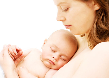 Sleeping baby on breast of his motherの写真素材