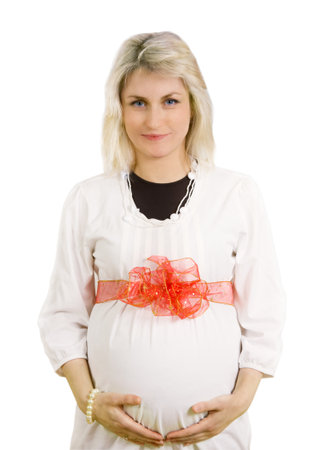 Portrait of pregnant woman with red bow isolated on whiteの写真素材