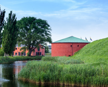 One of the red round parts of MalmÃ¶hus castle, a castle surrounded by a moat, in the middle of the city MalmÃ¶, Sweden.のeditorial素材