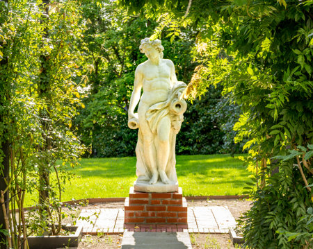 Marble statue in sunlight in green garden.のeditorial素材