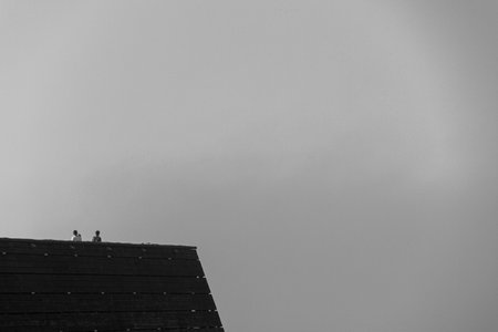 Three men on a viewing platform trying to see the sea but the fog is to thickの写真素材