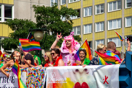 MalmÃ¶, Sweden - July 20, 2019: A float with lots of men and women partying, and in the middle a drag show artist dressed in pink is pumping her fist, during the annual pride parade in MalmÃ¶, Sweden.のeditorial素材